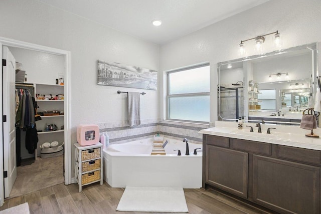 5106 La Piedra Ln, Killeen, TX 76549 - full bathroom with vanity, a bath, wood finished floors, and a spacious closet
