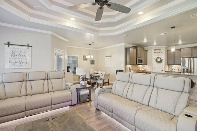 5106 La Piedra Ln, Killeen, TX 76549 - living area with a raised ceiling, crown molding, a ceiling fan, light wood-style floors, and recessed lighting