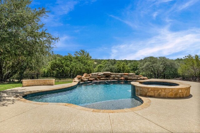 105 Quiet Oak Cv, Liberty Hill, TX 78642 - view of swimming pool with a pool with connected hot tub, a patio, and a view of trees
