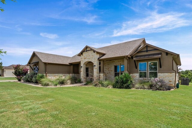 105 Quiet Oak Cv, Liberty Hill, TX 78642 - view of front of property featuring stone siding, stucco siding, a front yard, and a shingled roof