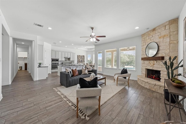105 Quiet Oak Cv, Liberty Hill, TX 78642 - living area with ceiling fan, light wood finished floors, a fireplace, and recessed lighting