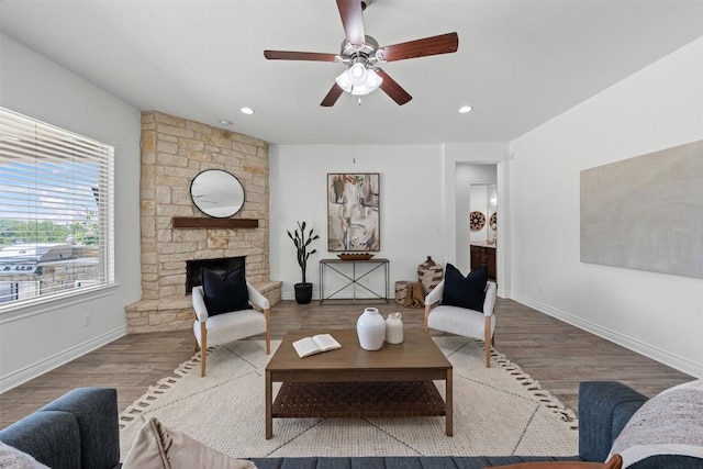 105 Quiet Oak Cv, Liberty Hill, TX 78642 - living area with a ceiling fan, wood finished floors, a stone fireplace, and recessed lighting