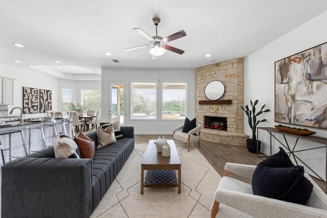 105 Quiet Oak Cv, Liberty Hill, TX 78642 - living room with light wood-style flooring, ceiling fan, recessed lighting, and a stone fireplace