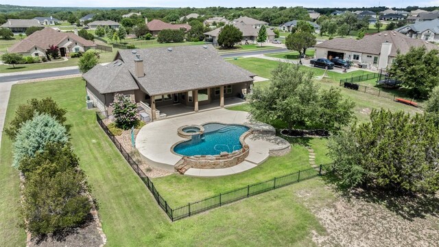 105 Quiet Oak Cv, Liberty Hill, TX 78642 - view of swimming pool with a fenced backyard, a residential view, a pool with connected hot tub, and a patio