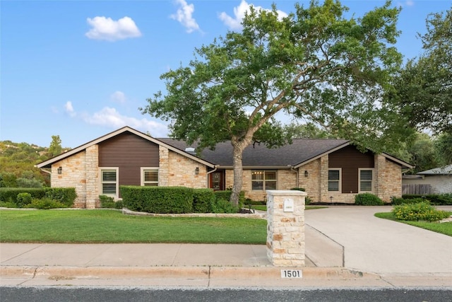1501 Johnny Miller Trl, Austin, TX 78746 - mid-century inspired home featuring stone siding, a front yard, and roof with shingles
