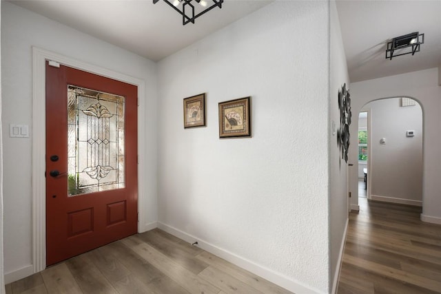 1501 Johnny Miller Trl, Austin, TX 78746 - foyer entrance featuring arched walkways and wood finished floors