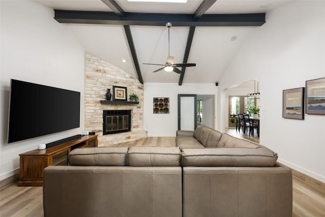 1501 Johnny Miller Trl, Austin, TX 78746 - living area featuring light wood finished floors, beam ceiling, high vaulted ceiling, a ceiling fan, and a fireplace
