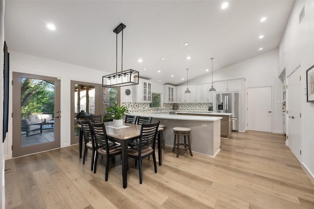 1501 Johnny Miller Trl, Austin, TX 78746 - dining area featuring light wood-type flooring, recessed lighting, and high vaulted ceiling