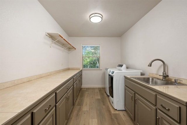1501 Johnny Miller Trl, Austin, TX 78746 - laundry area featuring separate washer and dryer, cabinet space, and light wood-style floors