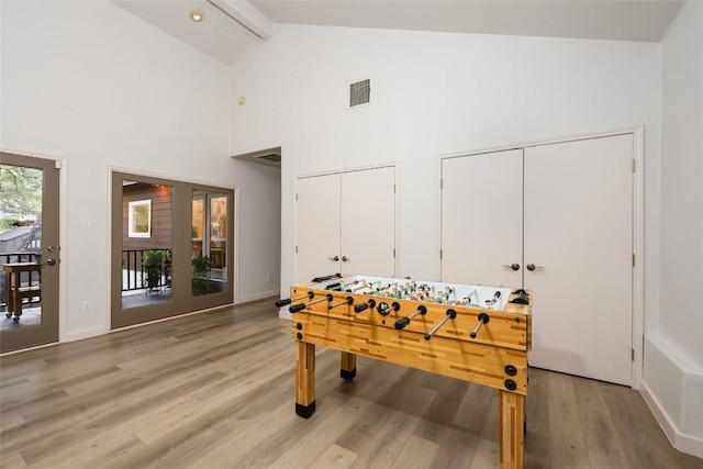 1501 Johnny Miller Trl, Austin, TX 78746 - recreation room with light wood finished floors, high vaulted ceiling, and beamed ceiling
