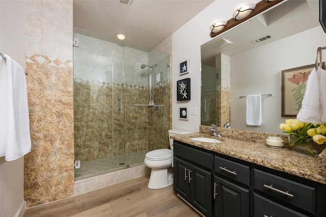 1501 Johnny Miller Trl, Austin, TX 78746 - full bathroom featuring wood finished floors, vanity, and a stall shower