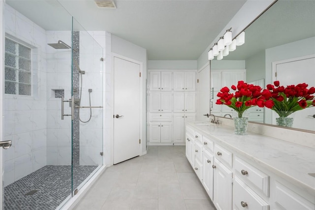 1501 Johnny Miller Trl, Austin, TX 78746 - full bath with a stall shower, tile patterned floors, and vanity