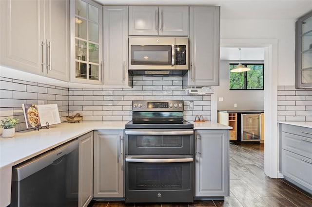 5308 Great Divide Dr, Bee Cave, TX 78738 - kitchen with stainless steel appliances, gray cabinets, wine cooler, and light countertops