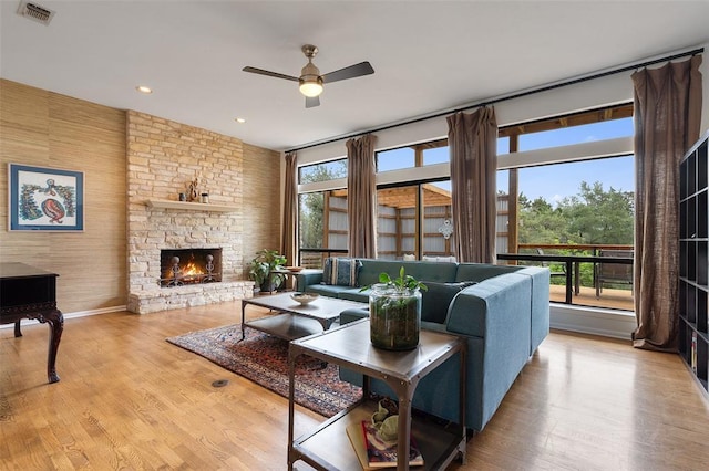 5308 Great Divide Dr, Bee Cave, TX 78738 - living area featuring a ceiling fan, wood finished floors, a stone fireplace, and recessed lighting