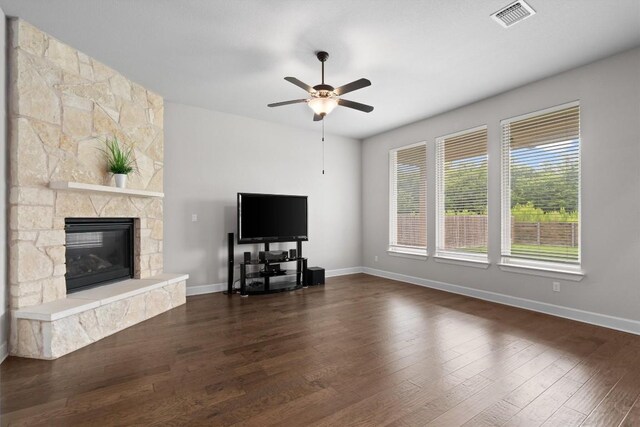 416 Hereford Loop, Hutto, TX 78634 - living room with ceiling fan, a stone fireplace, and dark wood-style flooring