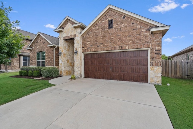 416 Hereford Loop, Hutto, TX 78634 - view of front facade featuring a garage, brick siding, stone siding, and driveway
