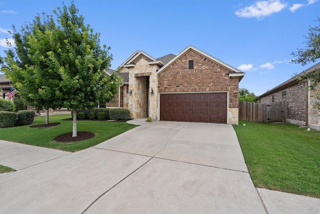 416 Hereford Loop, Hutto, TX 78634 - view of front facade featuring a garage, concrete driveway, stone siding, and brick siding
