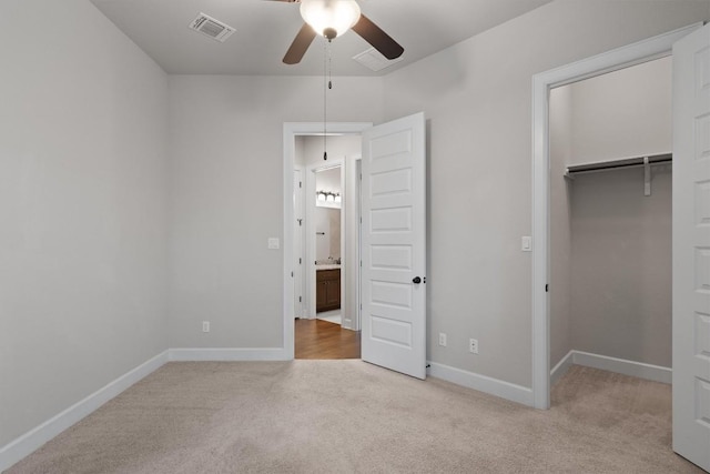 416 Hereford Loop, Hutto, TX 78634 - unfurnished bedroom featuring carpet, a closet, a walk in closet, and a ceiling fan