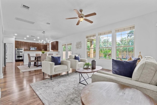 2003 Woodway Dr, Leander, TX 78641 - living area with recessed lighting, a chandelier, a ceiling fan, and wood finished floors