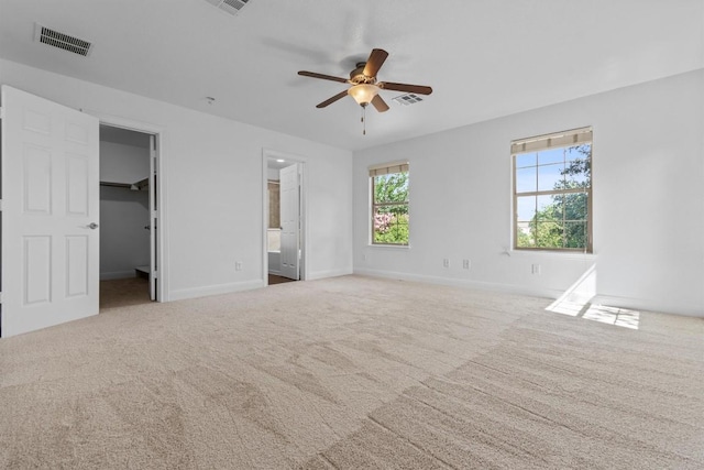 2003 Woodway Dr, Leander, TX 78641 - unfurnished bedroom featuring carpet, a spacious closet, ceiling fan, and ensuite bathroom