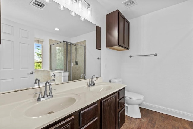 2003 Woodway Dr, Leander, TX 78641 - bathroom with a shower stall, double vanity, and wood finished floors
