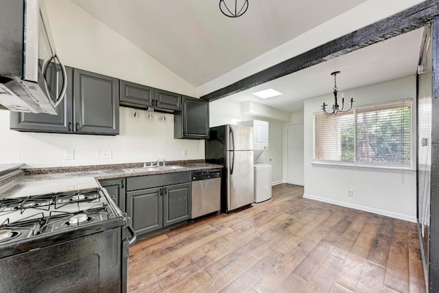 1010 W 23rd St Unit 2, Austin, TX 78705 - kitchen with appliances with stainless steel finishes, a chandelier, light wood-style flooring, pendant lighting, and vaulted ceiling