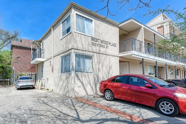 1010 W 23rd St Unit 2, Austin, TX 78705 - view of side of home featuring a balcony and stucco siding