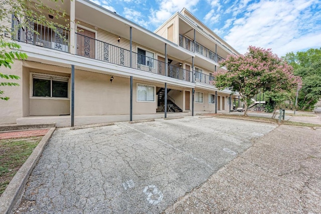 1010 W 23rd St Unit 2, Austin, TX 78705 - view of building exterior featuring stairs and uncovered parking