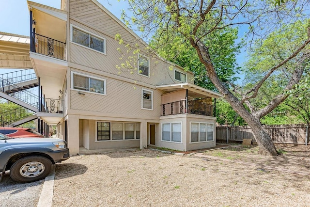 1010 W 23rd St Unit 2, Austin, TX 78705 - back of house featuring a balcony, stairway, and stucco siding