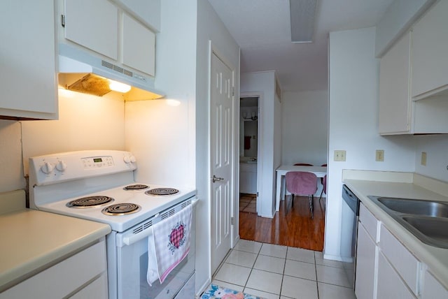 6903 Deatonhill Dr Unit 19, Austin, TX 78745 - kitchen featuring white range with electric cooktop, under cabinet range hood, light tile patterned flooring, and white cabinets