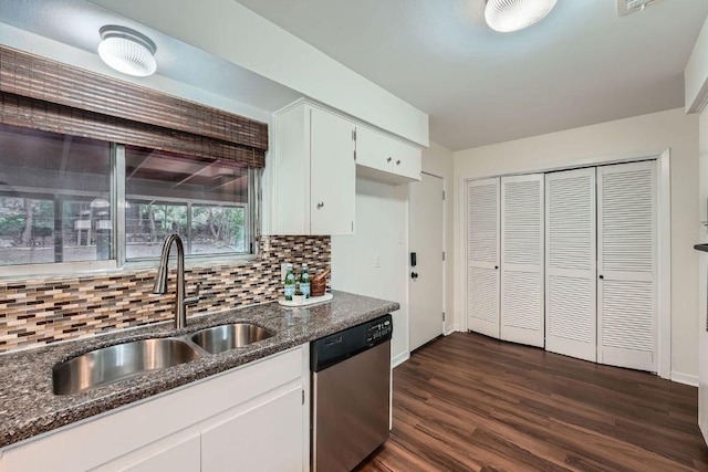 9504 Hansford Dr, Austin, TX 78753 - kitchen with stainless steel dishwasher, backsplash, dark stone counters, dark wood-style flooring, and white cabinetry