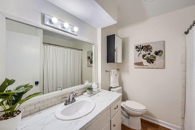 9504 Hansford Dr, Austin, TX 78753 - bathroom featuring vanity, wood finished floors, decorative backsplash, and a shower with shower curtain