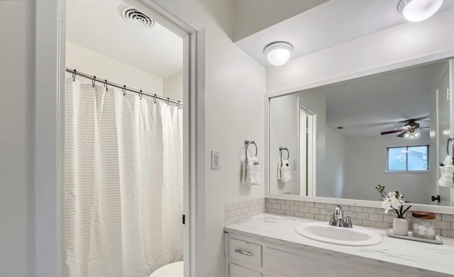 9504 Hansford Dr, Austin, TX 78753 - bathroom featuring tasteful backsplash, vanity, a ceiling fan, and a shower with shower curtain