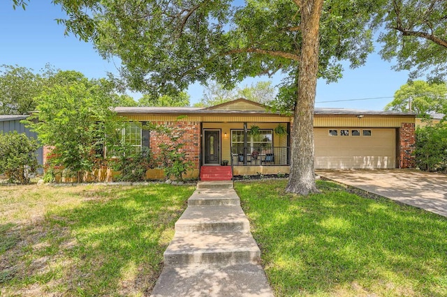 9504 Hansford Dr, Austin, TX 78753 - ranch-style home featuring an attached garage, a front yard, covered porch, and concrete driveway