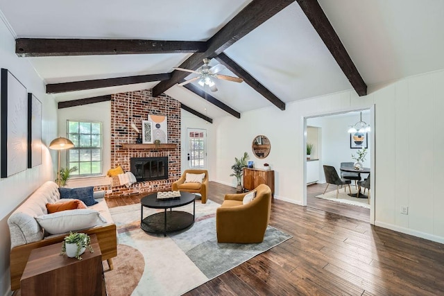 9504 Hansford Dr, Austin, TX 78753 - living room featuring hardwood / wood-style flooring, a fireplace, a ceiling fan, and a chandelier