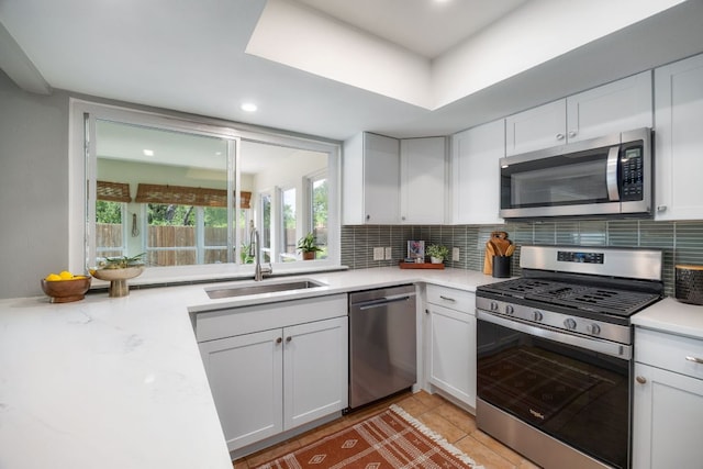 1406 Radam Cir, Austin, TX 78745 - kitchen with stainless steel appliances, backsplash, white cabinets, and recessed lighting