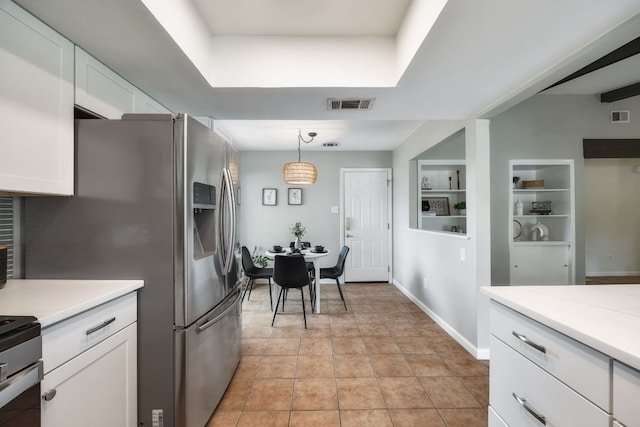 1406 Radam Cir, Austin, TX 78745 - kitchen featuring white cabinets, light countertops, built in shelves, decorative light fixtures, and appliances with stainless steel finishes