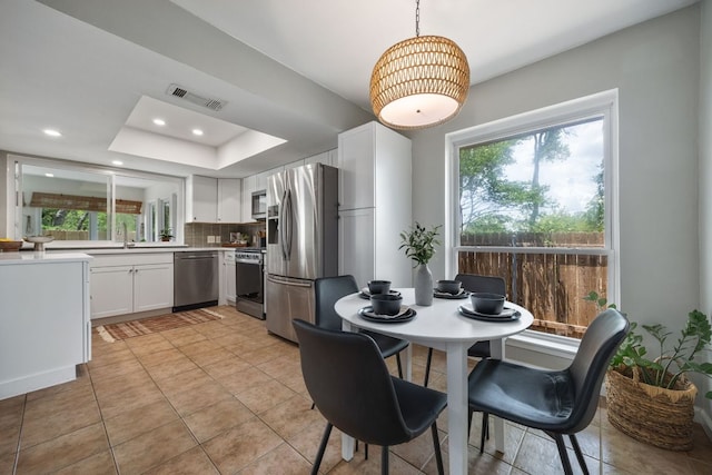 1406 Radam Cir, Austin, TX 78745 - dining space featuring plenty of natural light, light tile patterned flooring, recessed lighting, and a raised ceiling