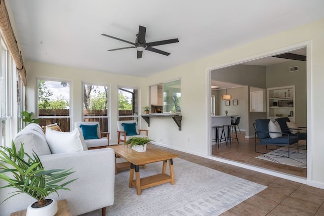 1406 Radam Cir, Austin, TX 78745 - tiled living room with ceiling fan and baseboards