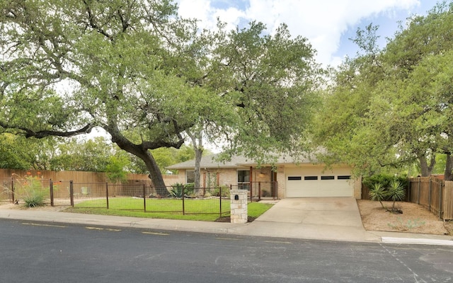 1406 Radam Cir, Austin, TX 78745 - view of front facade featuring concrete driveway and an attached garage