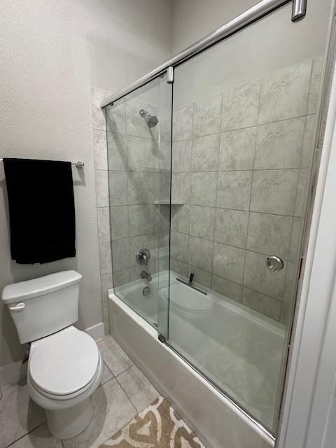 900 Elenora Dr, Leander, TX 78641 - bathroom featuring shower / bath combination with glass door and tile patterned flooring