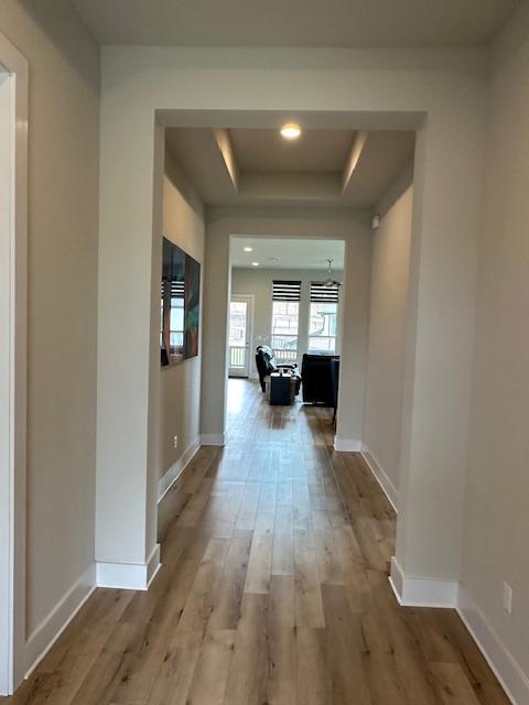 900 Elenora Dr, Leander, TX 78641 - hall featuring a raised ceiling and wood finished floors