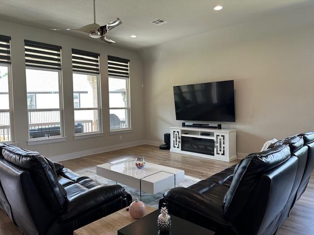 900 Elenora Dr, Leander, TX 78641 - living room featuring a ceiling fan, wood finished floors, recessed lighting, and a fireplace
