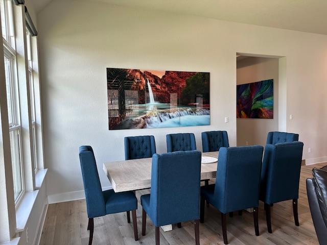 900 Elenora Dr, Leander, TX 78641 - dining room featuring wood finished floors and vaulted ceiling
