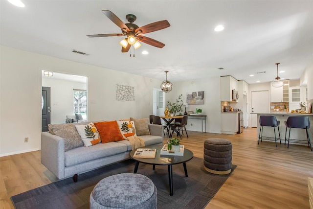4504 Bilboa Dr, Austin, TX 78759 - living room with light wood-style floors, ceiling fan, recessed lighting, and a chandelier
