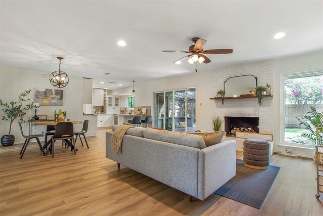 4504 Bilboa Dr, Austin, TX 78759 - living area featuring light wood-type flooring, recessed lighting, a ceiling fan, and a brick fireplace