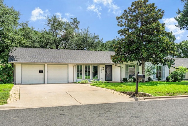 4504 Bilboa Dr, Austin, TX 78759 - view of front of house featuring an attached garage, driveway, a front yard, and roof with shingles