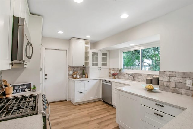 4504 Bilboa Dr, Austin, TX 78759 - kitchen with appliances with stainless steel finishes, backsplash, white cabinetry, open shelves, and recessed lighting