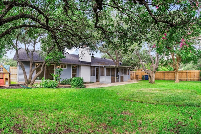 4504 Bilboa Dr, Austin, TX 78759 - back of house featuring a sunroom, a fenced backyard, and a chimney