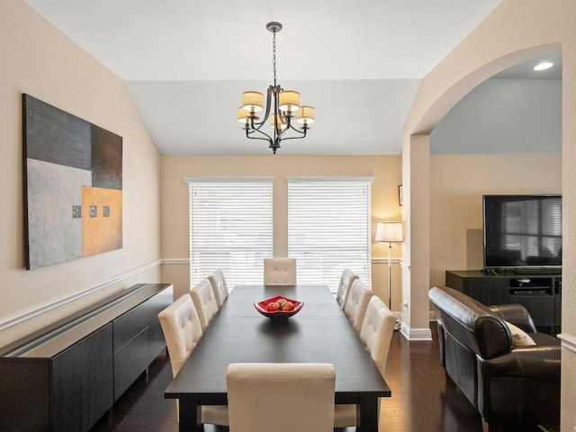 2520 Butler National Dr, Pflugerville, TX 78660 - dining space featuring vaulted ceiling, a chandelier, dark wood-style floors, and arched walkways